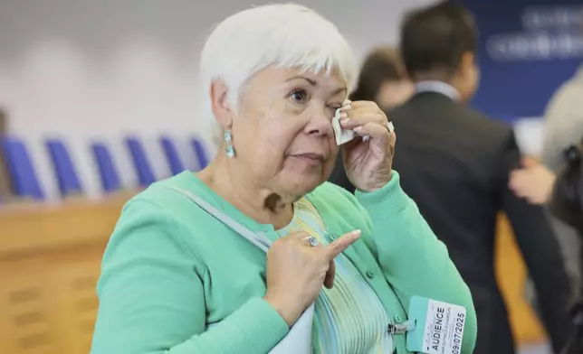 Netherlands' Grace van Zijtveld-Schardijn reacts after the European Court of Human Rights issued its judgment on Russian violations in Ukraine since 2014, including the downing of Malaysia Airlines flight MH17, Wednesday, July 9, 2025 in Strasbourg, eastern France. (AP Photo/Antonin Utz)
