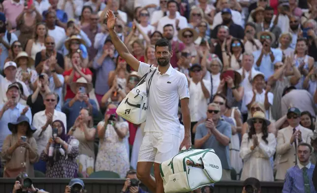 Serbia's Novak Djokovic leaves the court after losing to Italy's Jannik Sinner in a men's singles semifinal at the Wimbledon Tennis Championships in London, Friday, July 11, 2025. (AP Photo/Kin Cheung)