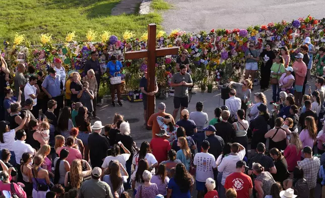 People gather for a vigil for flood victims on Friday, July 11, 2025, in Kerrville, Texas. (AP Photo/Gerald Herbert)