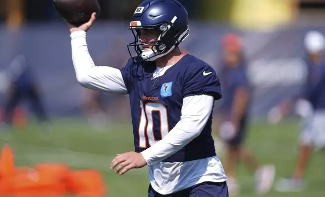 Denver Broncos quarterback Bo Nix takes part in drills during practice at the team's NFL football camp, Friday, July 25, 2025, in Centennial, Colo. (AP Photo/David Zalubowski)