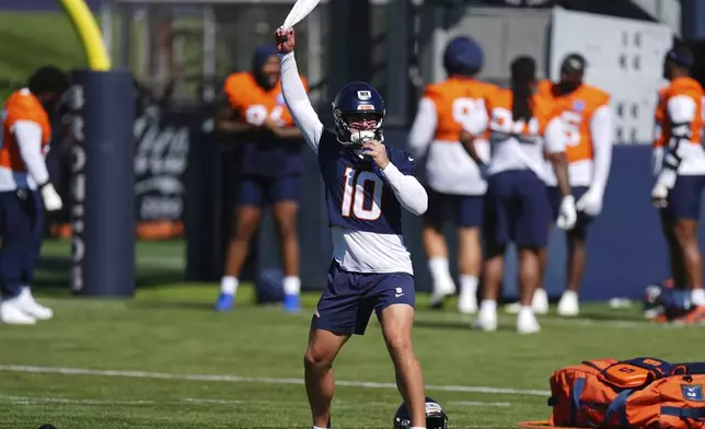 Denver Broncos quarterback Bo Nix warms up during Back Together Weekend at the team's NFL football training camp, Saturday, July 26, 2025, in Centennial, Colo. (AP Photo/David Zalubowski)