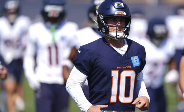 Denver Broncos quarterback Bo Nix runs during an NFL football practice Friday, July 25, 2025, in Centennial, Colo. (AP Photo/David Zalubowski)