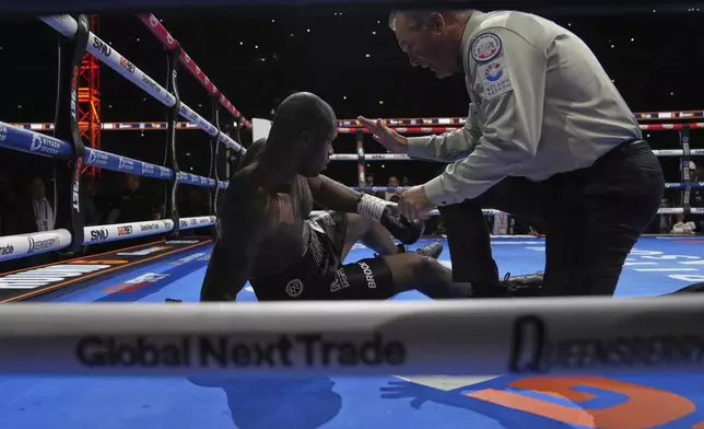 Britain's Daniel Dubois is in on the floor after a knockout by Ukraine's Oleksandr Usyk during the undisputed world heavyweight boxing title fight In London, Saturday, July 19, 2025. (AP Photo/Frank Augstein)
