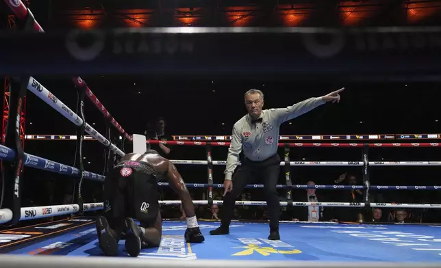 Britain's Daniel Dubois is in on the floor after a knockout by Ukraine's Oleksandr Usyk during the undisputed world heavyweight boxing title fight In London, Saturday, July 19, 2025. (AP Photo/Frank Augstein)