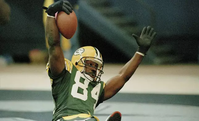 FILE - Green Bay Packers wide receiver Sterling Sharpe celebrates a third quarter touchdown against the Dallas Cowboys in Irving, Texas, Nov. 24, 1994. Photo/Tim Sharpe)