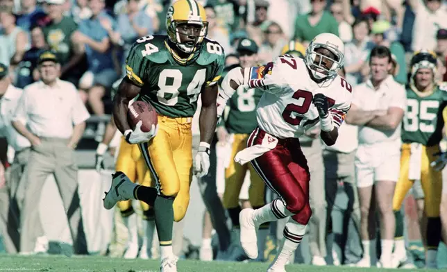 FILE - Green Bay Packers wide receiver Sterling Sharpe (84), chased by Phoenix Cardinals Jay Taylor, heads towards the goal line to score the first touchdown of an NFL football game in Tempe, Ariz., Nov. 18, 1990. (AP Photo/Jeff Kida)