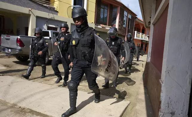 Police take part in an operation against alleged drug traffickers in La Mesilla, Guatemala, near the border with Mexico, Wednesday, July 30, 2025. (AP Photo/Moises Castillo)