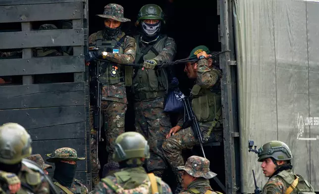 Soldiers gather after their operation against alleged drug traffickers in La Mesilla, Guatemala, near the border with Mexico, Wednesday, July 30, 2025. (AP Photo/Moises Castillo)