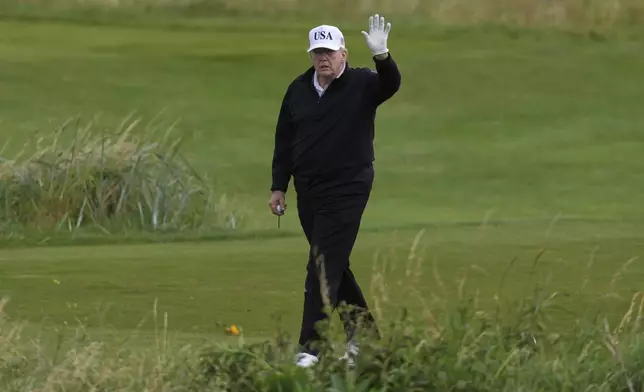 President Donald Trump waves to reporters as he plays golf at the Trump Turnberry golf course in Turnberry, Scotland, Saturday, July 26, 2025.(AP Photo/Alastair Grant)