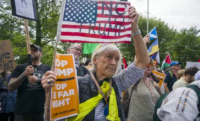 People take part in a Stop Trump Scotland protest outside the US Consulate in Edinburgh, as US President Donald Trump begins his five-day private trip to the country at his Turnberry golf course in South Ayrshire on Saturday July 26, 2025. ( Jane Barlow /PA via AP)