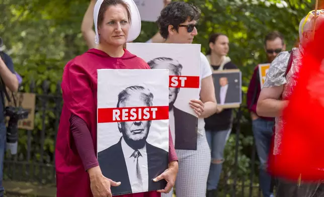People take part in a Stop Trump Scotland protest outside the US Consulate in Edinburgh, as US President Donald Trump begins his five-day private trip to the country at his Turnberry golf course in South Ayrshire on Saturday July 26, 2025. (Jane Barlow /PA via AP)