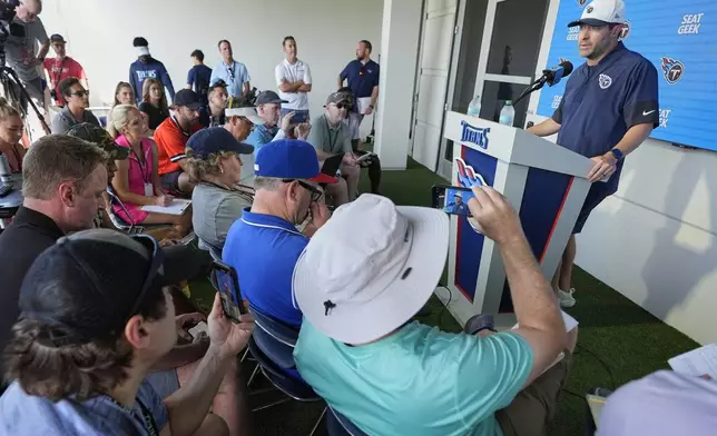 Tennessee Titans head coach Brian Callahan, right, speaks during a news conference before practice at the team's NFL football training camp Wednesday, July 23, 2025, in Nashville, Tenn. (AP Photo/George Walker IV)