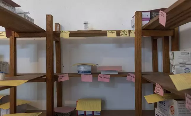 An almost-empty shelf, that once held contraceptives for patients, is seen at the Palala Clinic in Bong County, Liberia, Friday, June 13, 2025. (AP Photo/Annie Risemberg)