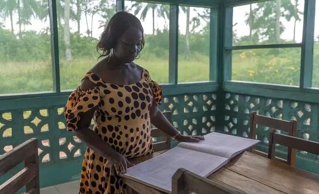 Viola K. Major, a midwife who runs maternal "waiting homes" in Bong County, Liberia, which were partly funded by USAID, stands in the vestibule of one of the homes, on Thursday, June 12, 2025. (AP Photo/Annie Risemberg)