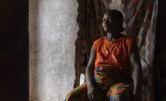 Gbango Kemu, 36, who got pregnant after failing to get access to contraceptives, sits with her daughter Garmah at their house in Bong County, Liberia, Friday, June 13, 2025. (AP Photo/Annie Risemberg)
