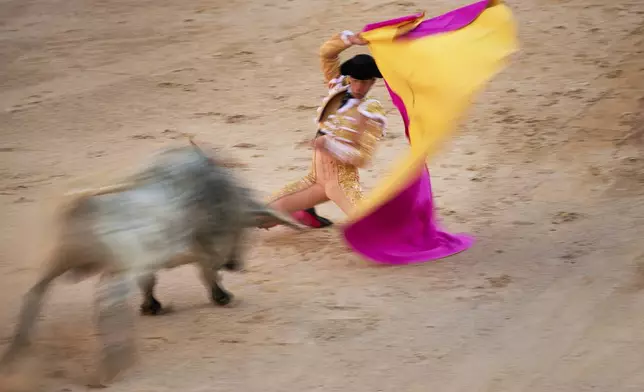 Spanish bullfighter Pepe Moral performs in a bullfight at the San Fermin Festival in Pamplona, northern Spain, on Tuesday July 8, 2025. (AP Photo/Miguel Oses)