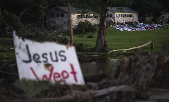 Campers belongings sit outside one of Camp Mystic's cabins near the Guadalupe River, Monday, July 7, 2025, in Hunt, Texas, after a flash flood swept through the area. (AP Photo/Eli Hartman)