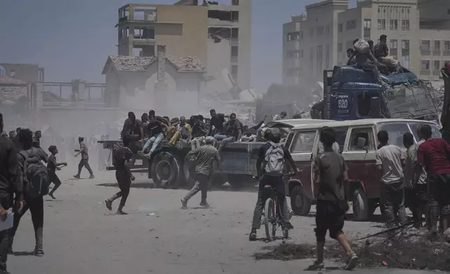 Palestinians hold onto an aid truck returning to Gaza City from the northern Gaza Strip on Tuesday, July 22, 2025. (AP Photo/Jehad Alshrafi)