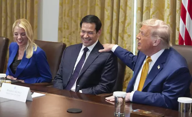 President Donald Trump, right, puts his hand on shoulder of Secretary of State Marco Rubio, center, as Attorney General Pam Bondi, left, looks on during a cabinet meeting at the White House, Tuesday, July 8, 2025, in Washington. (AP Photo/Evan Vucci)