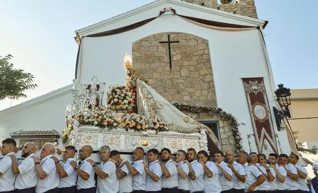 Catholic faithful carry a statue of the Virgin of Carmen during a religious procession in Estepona, southern Spain, Wednesday, July 16, 2025. (AP Photo/Claudia Rosel)