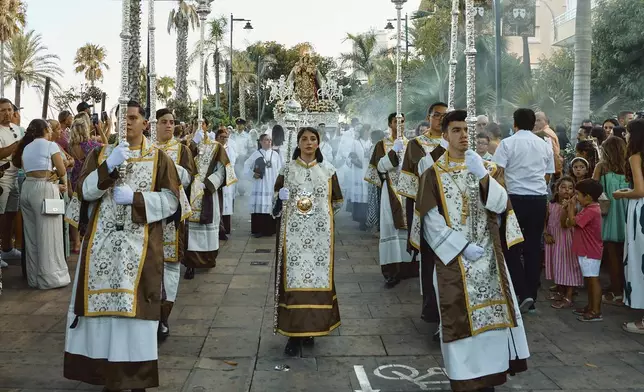 Catholic faithful carry a statue of the Virgin of Carmen during a religious procession in Estepona, southern Spain, Wednesday, July 16, 2025. (AP Photo/Claudia Rosel)