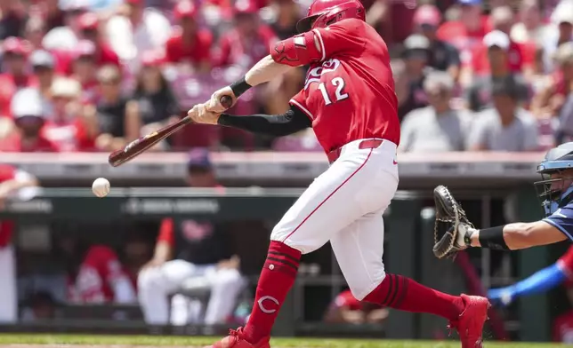 Cincinnati Reds' Austin Hays hits an RBI single during the first inning of a baseball game against the Tampa Bay Rays, Sunday, July 27, 2025, in Cincinnati. (AP Photo/Jeff Dean)