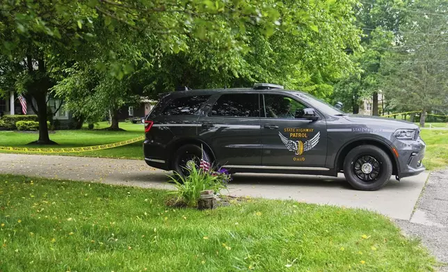 An Ohio State Highway Patrol car blocks access to a driveway in Howland, Monday, June 30, 2025, near where a day earlier a plane crashed on take off killing all onboard. (AP Photo/Sue Ogrocki)
