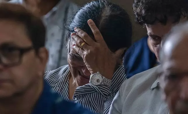 Mother of Clive Kunder, co-pilot of the Air India flight that crashed in Ahmedabad last month, mourns during a prayer meeting for the Air India crew, at a church in Mumbai, India, Saturday, July 12, 2025. (AP Photo/ Rafiq Maqbool)