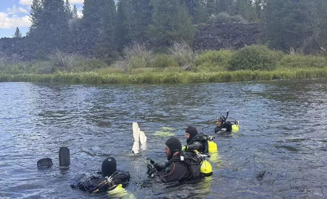 In this photo provided by the Deschutes, Ore., County Sheriff's Office, divers search for those missing following a fatal waterfall accident on Saturday, July 19, 2025, at Dillon Falls, on the Deschutes River near Bend, Ore. (Deschutes County Sheriff's Office via AP)