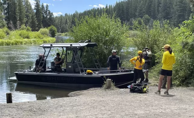 In this photo provided by the Deschutes, Ore., County Sheriff's Office, search teams search for the missing following a fatal waterfall accident on Saturday, July 19, 2025, at Dillon Falls, on the Deschutes River near Bend, Ore. (Deschutes County Sheriff's Office via AP)
