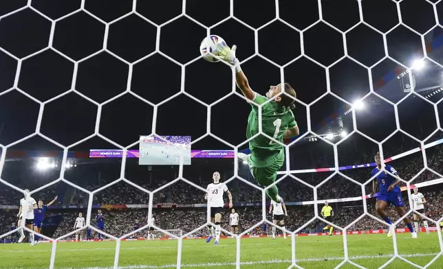 Germany goalkeeper Ann-Katrin Berger makes a save during the Women's Euro 2025 quarterfinals soccer match between France and Germany at St. Jakob-Park in Basel, Switzerland, Saturday, July 19, 2025. (Michael Buholzer/Keystone via AP)