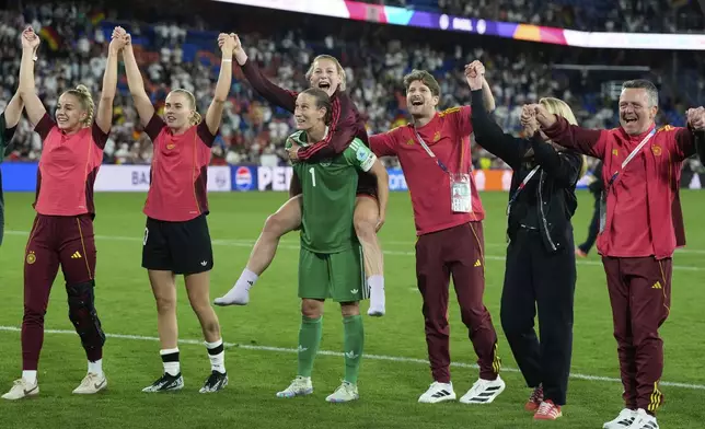 Germany's Sarai Linder, who got injured during the match, celebrates on the shoulders of goalkeeper Ann-Katrin Berger in front of the fans after winning the Women's Euro 2025 quarterfinals soccer match between France and Germany at St. Jakob-Park in Basel, Switzerland, Saturday, July 19, 2025. (AP Photo/Alessandra Tarantino)