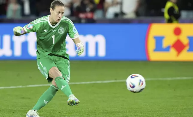 Germany goalkeeper Ann-Katrin Berger shoots to score during a penalty shootout during the Women's Euro 2025 quarterfinals soccer match between France and Germany at St. Jakob-Park in Basel, Switzerland, Saturday, July 19, 2025. (AP Photo/Martin Meissner)