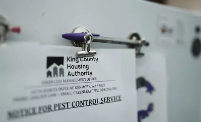 A notice from King County Housing Authority is clipped to the fridge at the apartment of Havalah Hopkins, a single mother who lives in government-subsidized housing with her teenage son, Thursday, July 10, 2025, in Woodinville, Wash. (AP Photo/Lindsey Wasson)
