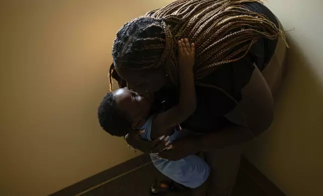 Aaliyah Barnes and her son, Aarmoni Barnes, 3, hug in a hallway at the Family Scholar House Owsley Brown Franzier Academic Services Center, Friday, July 11, 2025, in Louisville, Ky. (AP Photo/Jon Cherry)