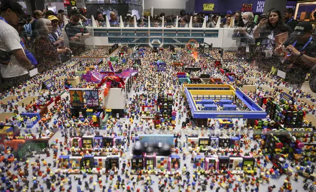 Onlookers view a Lego installation during preview night for Comic-Con International on Wednesday, July 23, 2025, in San Diego. (Photo by Andrew Park/Invision/AP)
