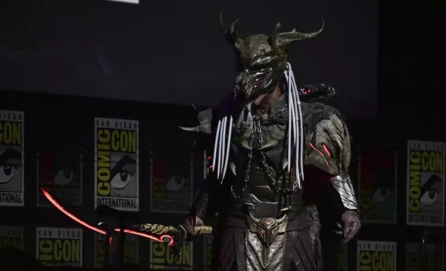 A person dressed as the character predator attends a panel for "Predator: Badlands" during Comic-Con International on Friday, July 25, 2025, in San Diego. (Photo by Richard Shotwell/Invision/AP)