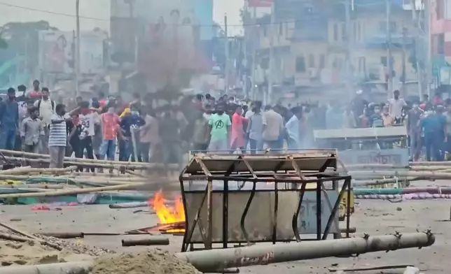 In this image made from a video, supporters of the ousted Prime Minister Sheikh Hasina clash with the police in Gopalganj, Bangladesh, Wednesday, July 16, 2025. (AP Photo)