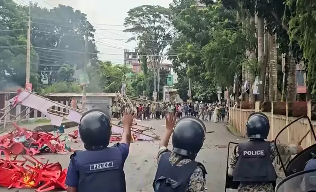In this image made from a video, supporters of the ousted Prime Minister Sheikh Hasina clash with the police in Gopalganj, Bangladesh, Wednesday, July 16, 2025. (AP Photo)