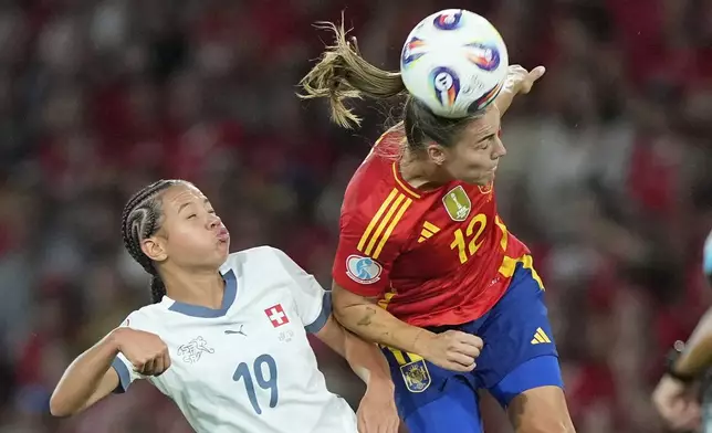 Spain's Patri Guijarro heads the ball ahead of Switzerland's Iman Beney during the Women's Euro 2025 quarterfinals soccer match between Spain and Switzerland at Stadion Wankdorf in Bern, Switzerland, Friday, July 18, 2025. (AP Photo/Martin Meissner)