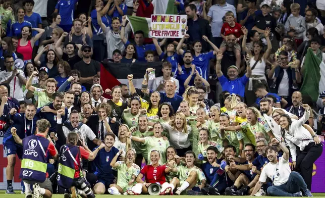 Soccer players and staff from Italy celebrate their victory after the Women's Euro 2025 quarterfinals soccer match between Norway and Italy at Stade de Geneve in Geneva, Switzerland, Wednesday, July 16, 2025. (Jean-Christophe Bott/Keystone via AP)