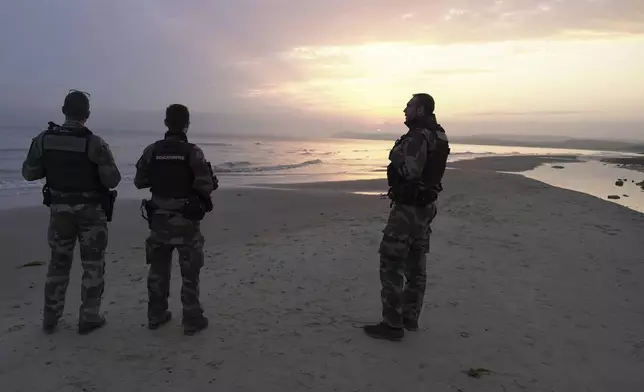 Gendarmes patrol on Chatelet beach, north of Boulogne-sur-Mer, northern France, Wednesday July 2, 2025. (AP Photo/John Leicester)