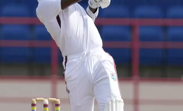 West Indies' Alzarri Joseph hits a six from a delivery of Australia's captain Pat Cummins during day two of the second cricket Test match at National Cricket Stadium in St. George's, Grenada, Friday, July 4, 2025. (AP Photo/Ricardo Mazalan)