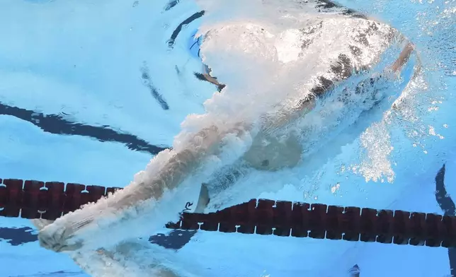 Leon Marchand of France competes in the men's 200-meter individual medley heats at the World Aquatics Championships in Singapore, Wednesday, July 30, 2025. (AP Photo/Lee Jin-man)