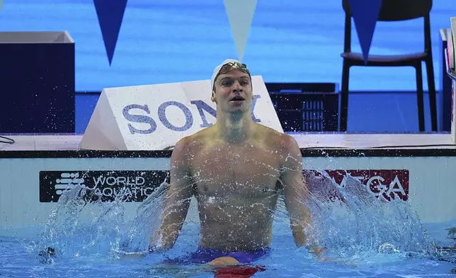 Leon Marchand of France celebrates after competing in the men's 200-meter individual medley semifinals at the World Aquatics Championships in Singapore, Wednesday, July 30, 2025. (AP Photo/Ng Han Guan)