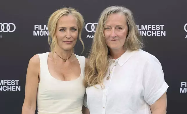 Actress Gillian Anderson, left, and author Raynor Winn pose ahead of the at the 42nd Munich Film Festival in Munich, Germany, July 1, 2025. (Felix Hörhager/dpa via AP)