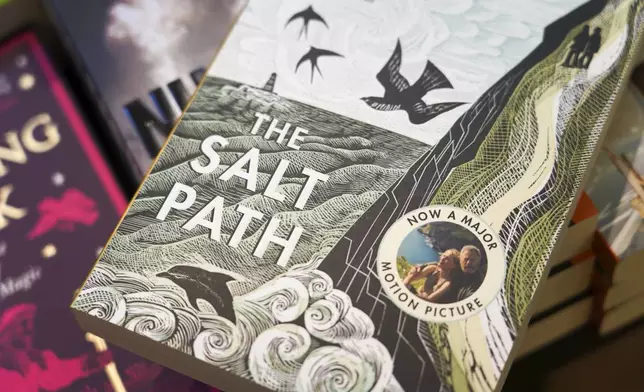 A copy of "The Salt Path", by Raynor Winn is on display in a book store, in London, Friday, July 11, 2025. (AP Photo/Alberto Pezzali)