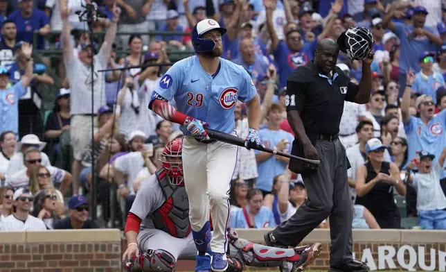 Chicago Cubs' Michael Busch hits a two-run home run against the St. Louis Cardinals during the third inning of a baseball game Friday, July 4, 2025, in Chicago. (AP Photo/David Banks)