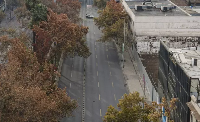 FILE - A police tent covers the body of a person who was beheaded and left on Bernardo O'Higgins Avenue in Santiago, Chile, May 28, 2023. (AP Photo/Esteban Felix, File)