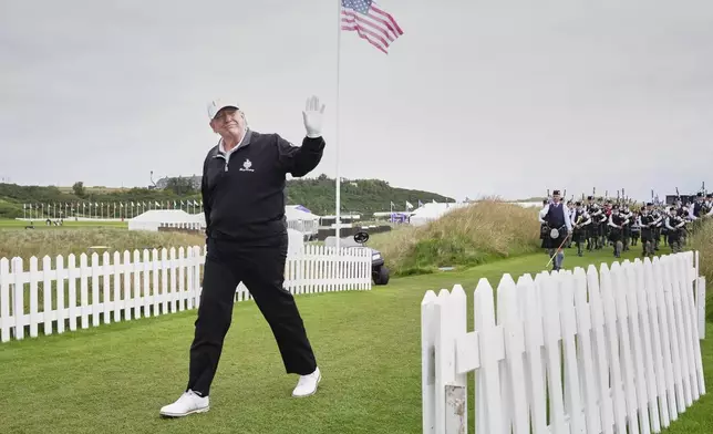 President Donald Trump arrives, followed by a bagpiper band, at the opening ceremony for the Trump International Golf Links golf course, near Aberdeen, Scotland, Tuesday, July 29, 2025. (AP Photo/Jacquelyn Martin)